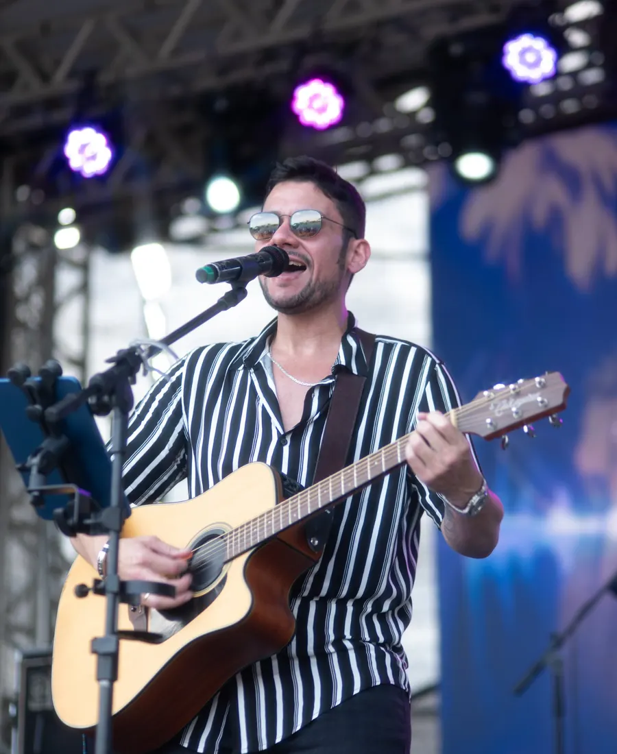 Léo Moraes cantando e tocando violão